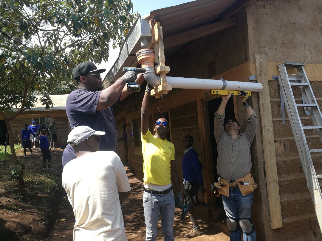The EWB team rigging their custom gutters and pipes at Imurtot