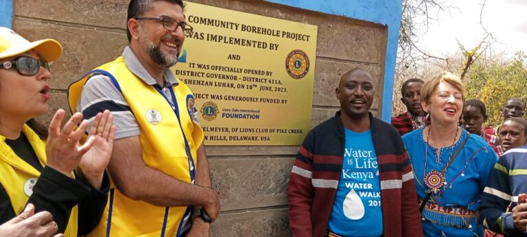 Joined by members of the Lions Club, WILK co-founders Larasha and Joyce unveil the new borehole in Nooriro.