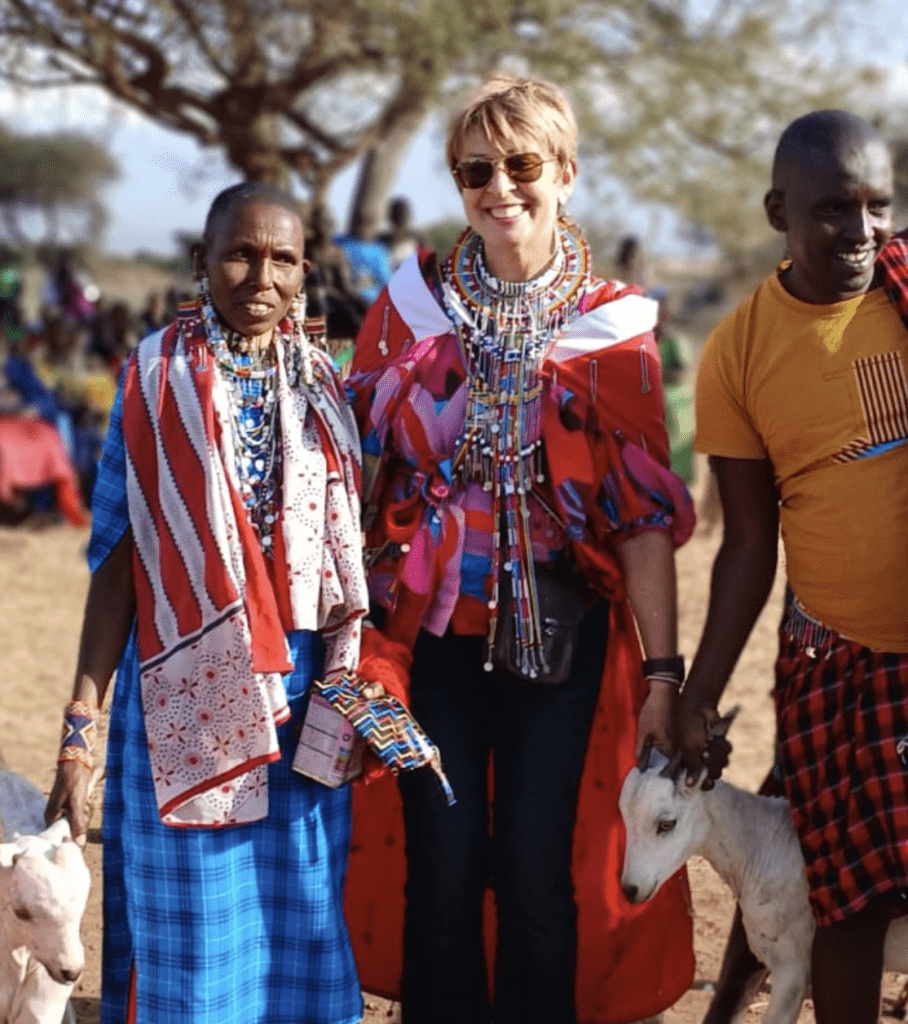 a group of people standing with goats